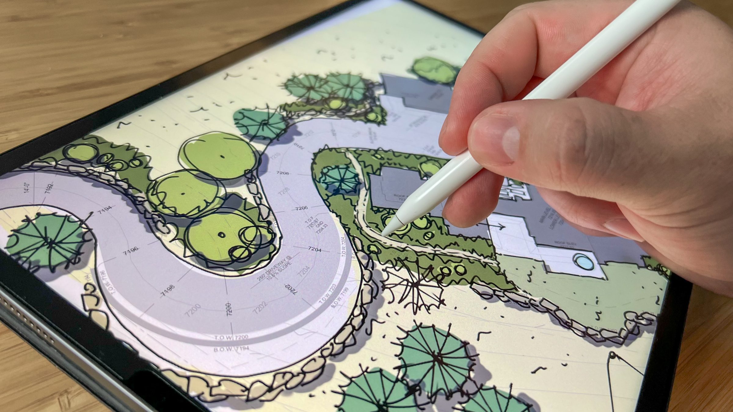 Digital landscape design on tablet with stylus.