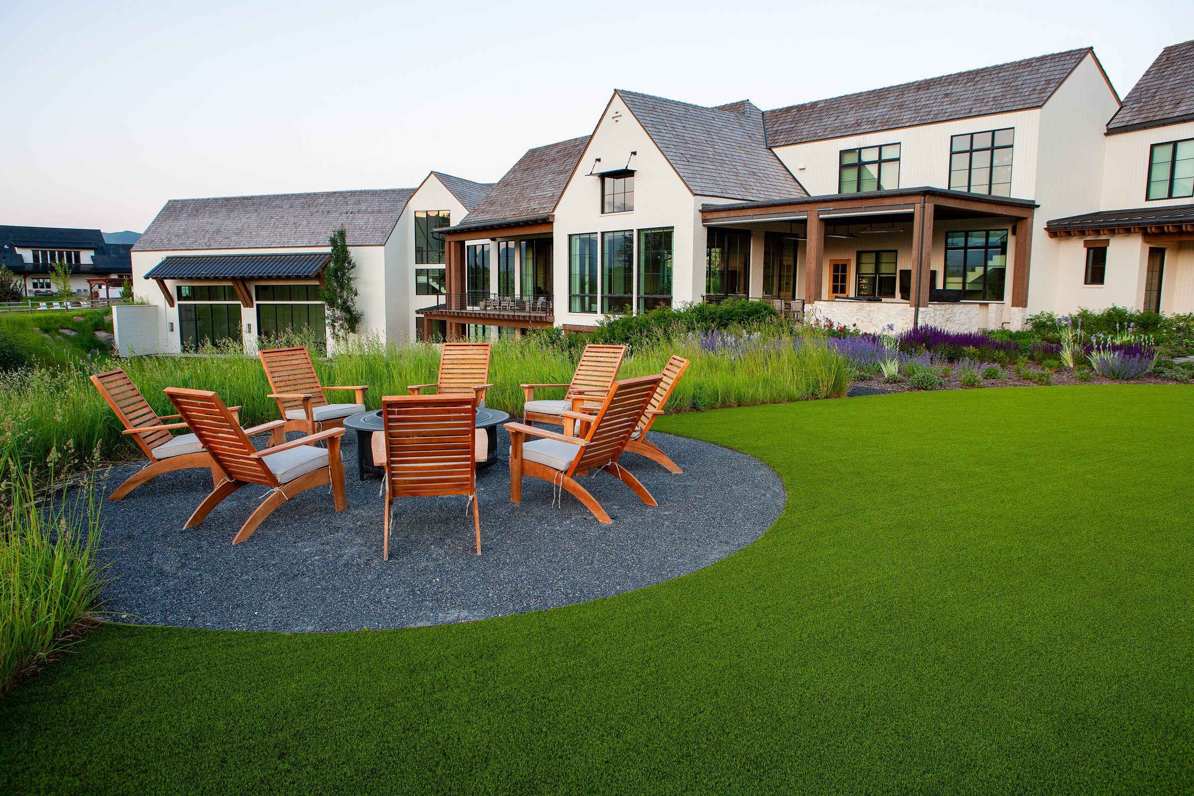 Modern house with landscaped yard and seating area