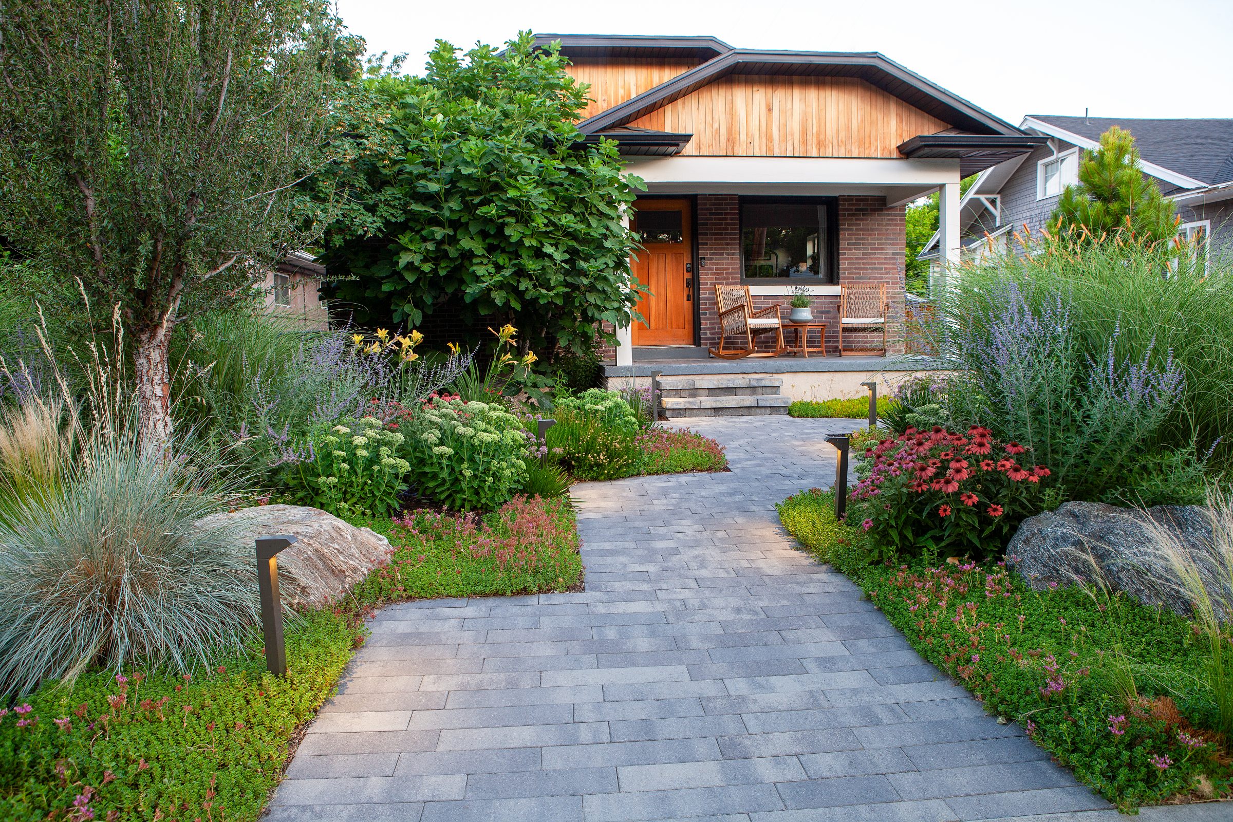 Charming garden path to cozy house entrance.