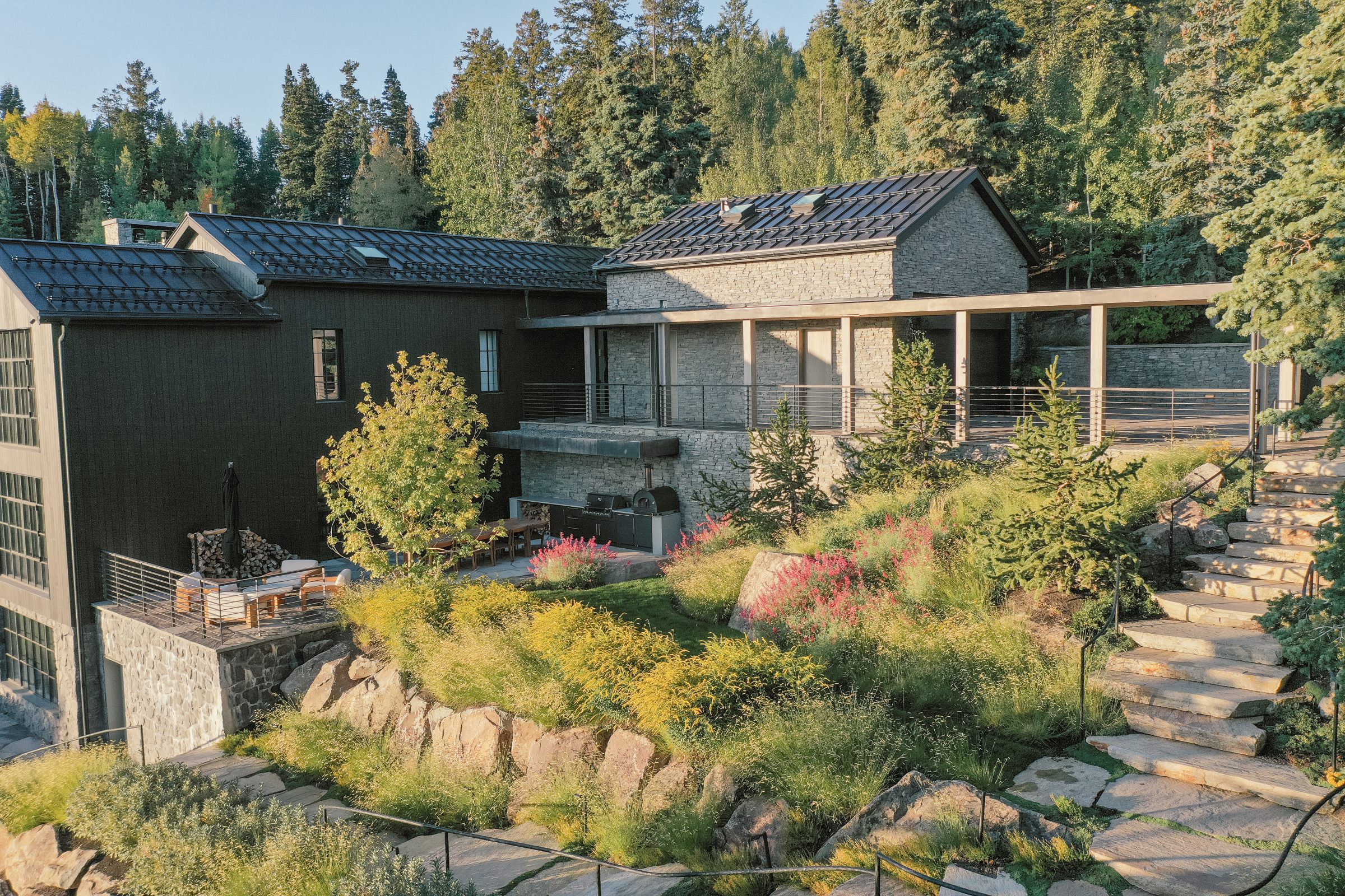 Modern house with lush garden and stone terrace
