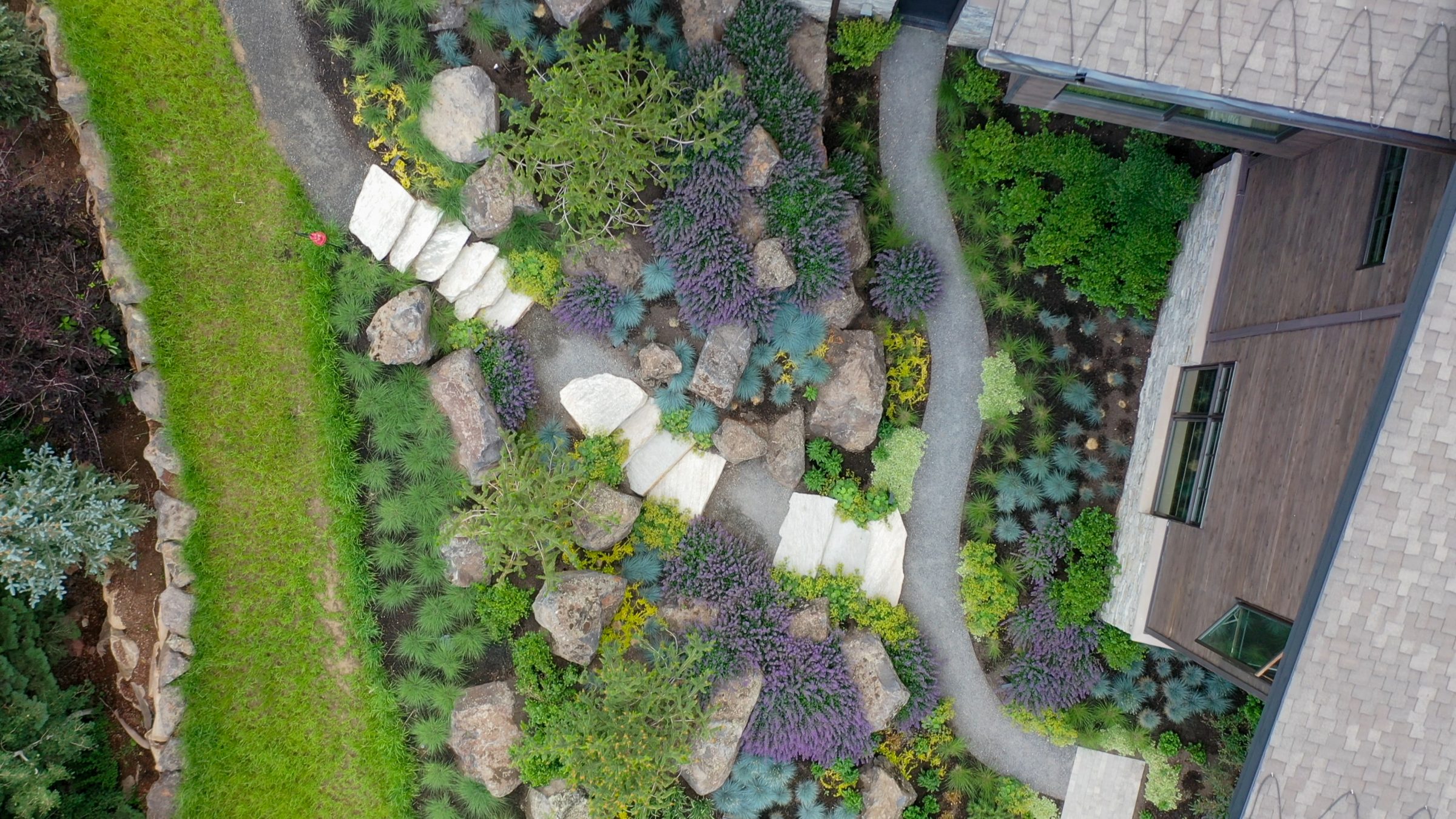 Aerial view of landscaped garden with stone paths.