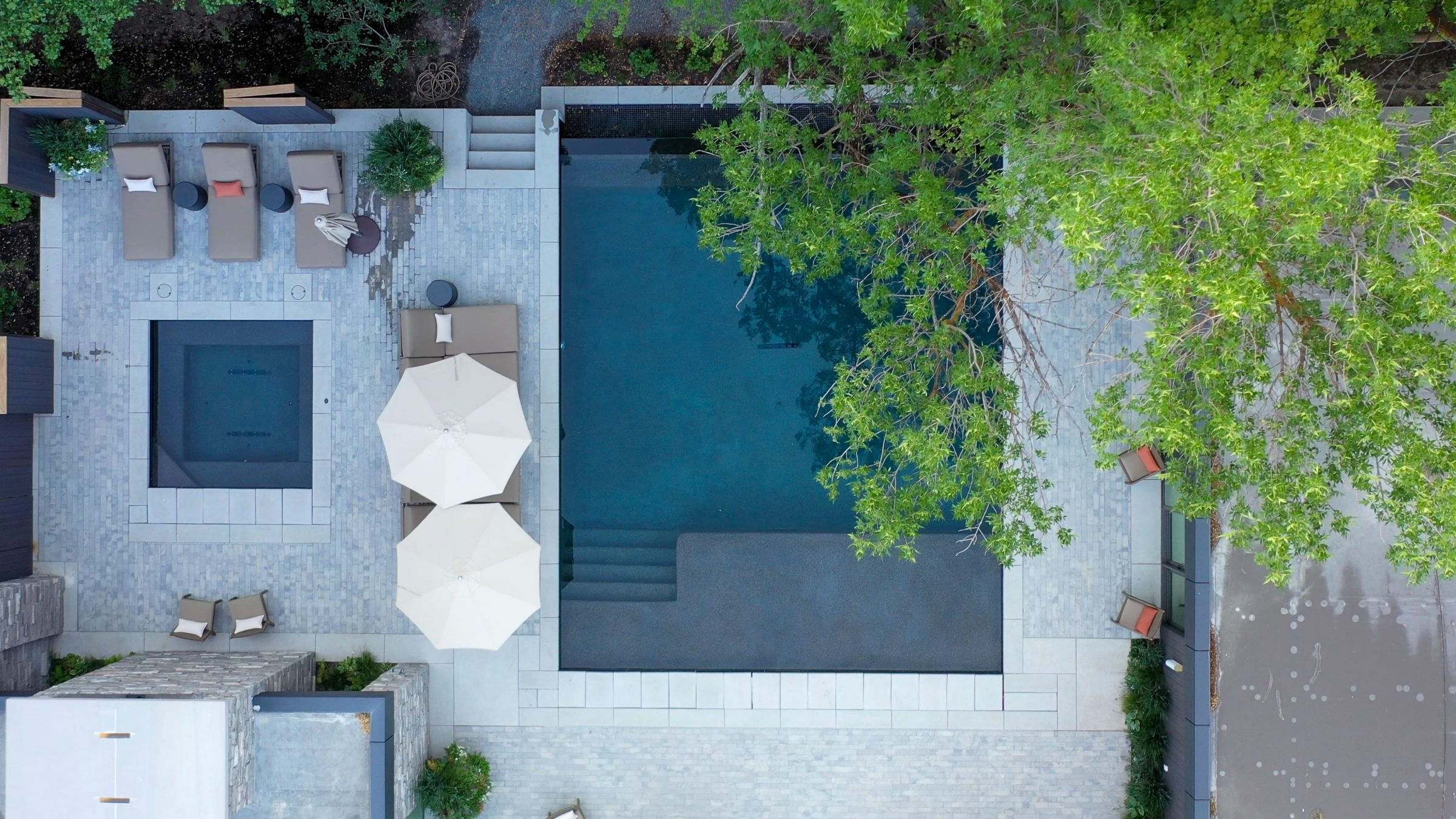 Aerial view of pool with loungers and parasols.