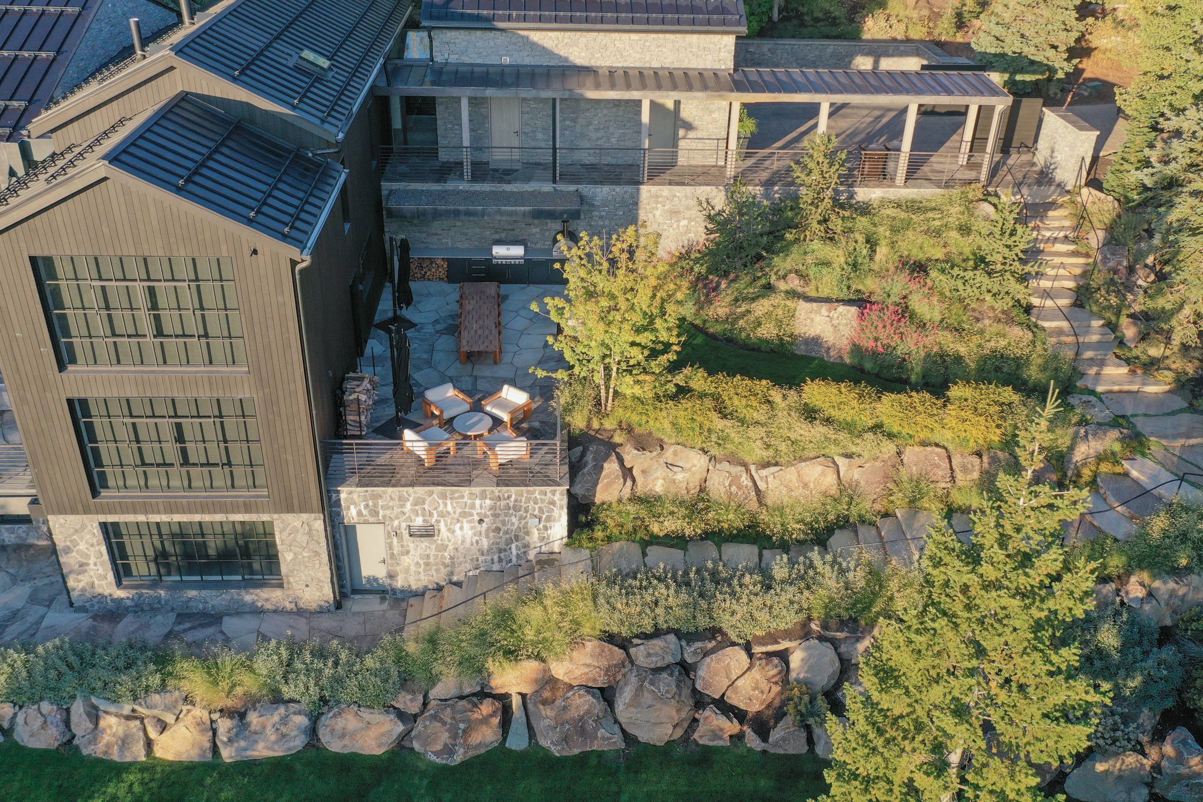 Aerial view of modern house with stone patio.