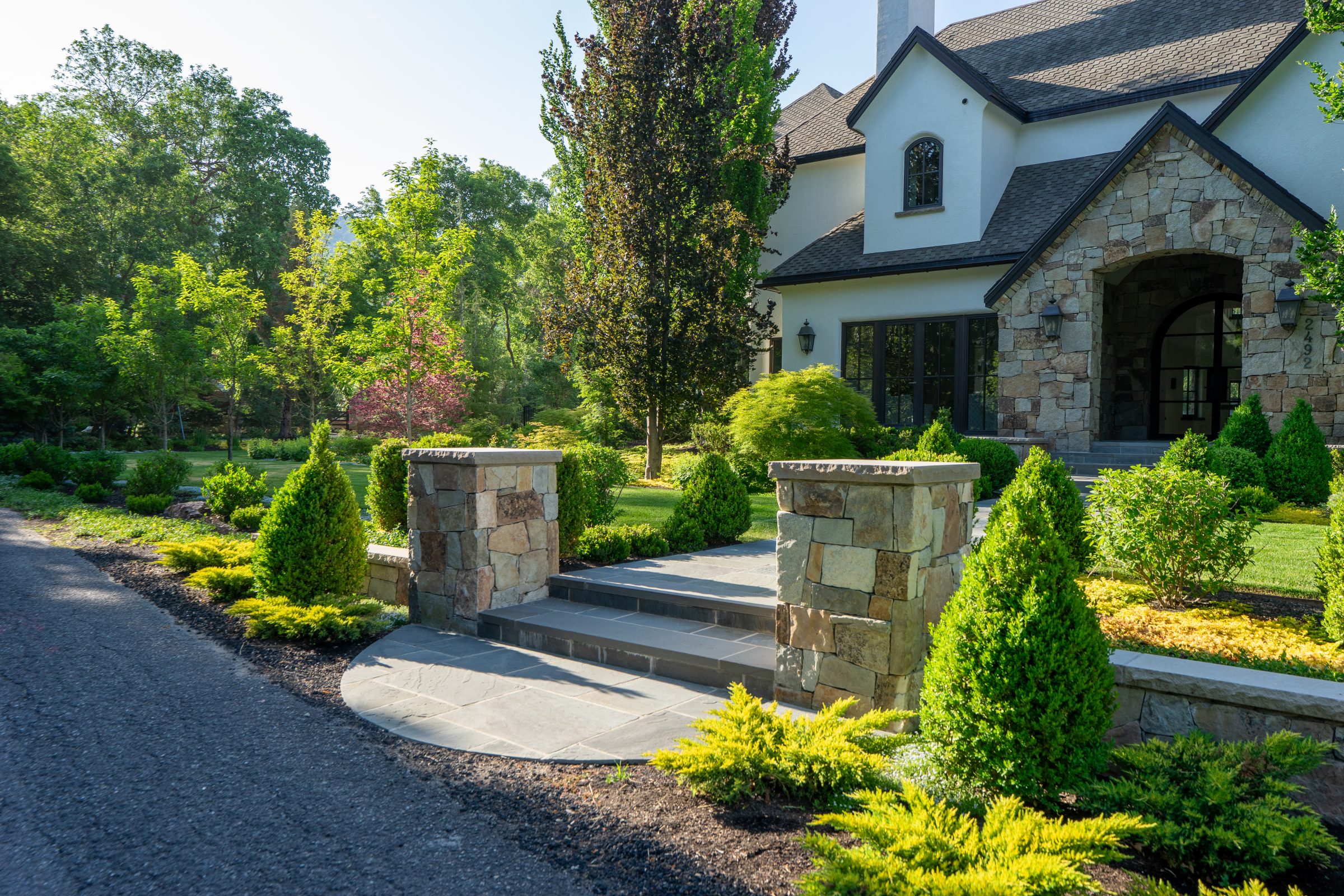 Elegant house with landscaped garden and stone entrance