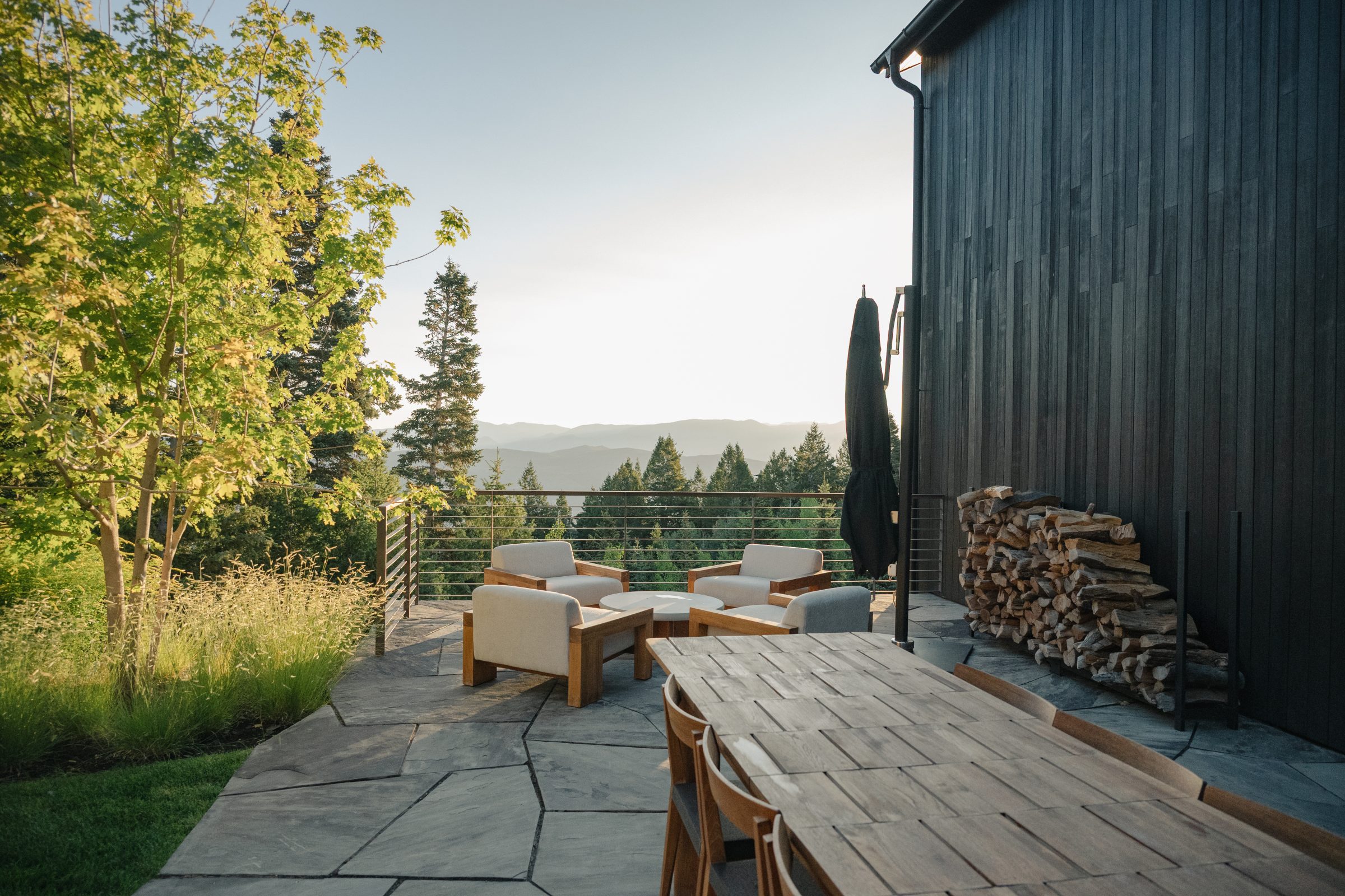 Outdoor patio with mountain view and seating area.