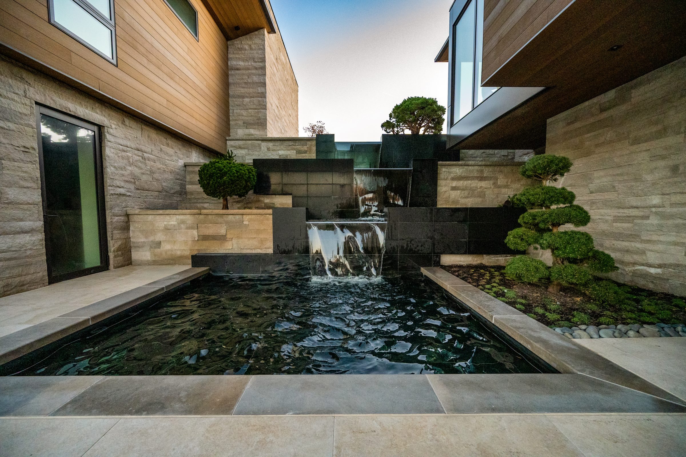 Modern courtyard with waterfall and pool