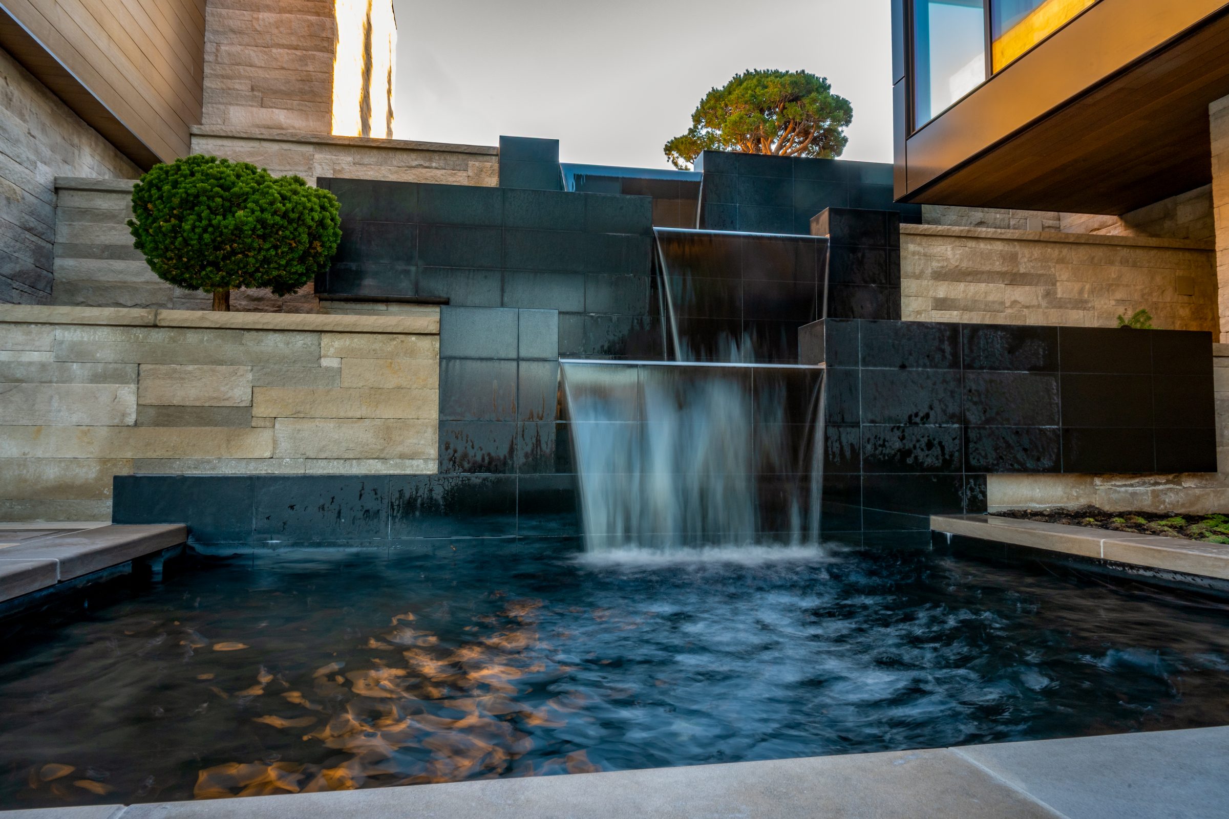 Modern cascading water feature with stone walls